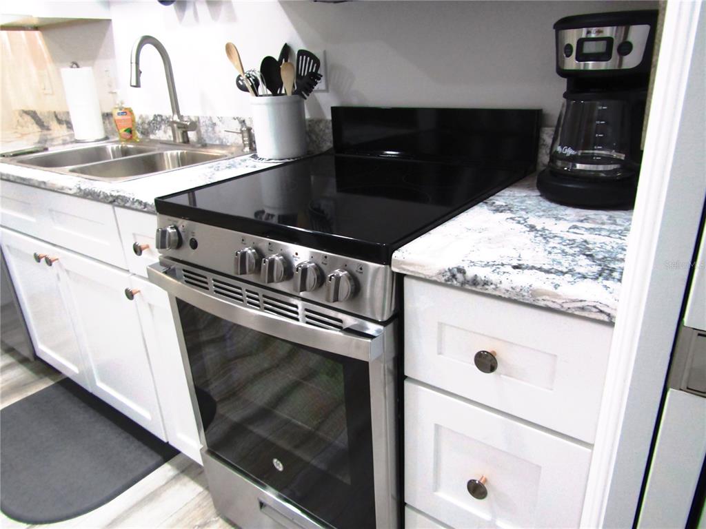 3531 Longmeadow, Unit 16 Sarasota, FL 34235 - Photo 28 of 29 a close view of a stove a microwave and cabinets