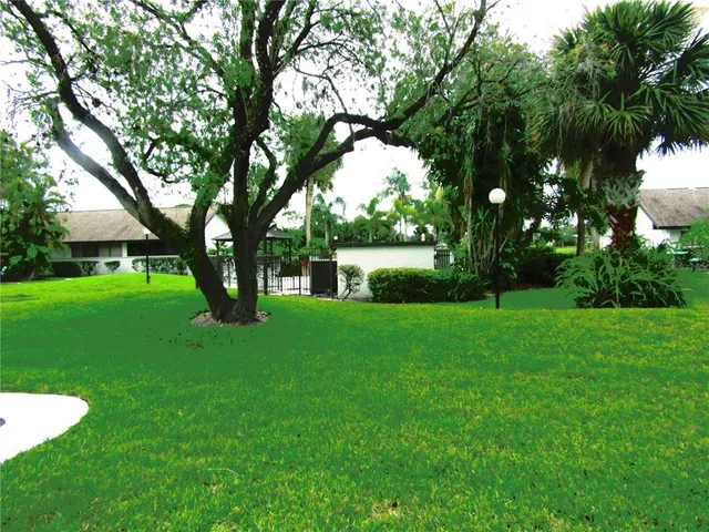 a view of green field with trees