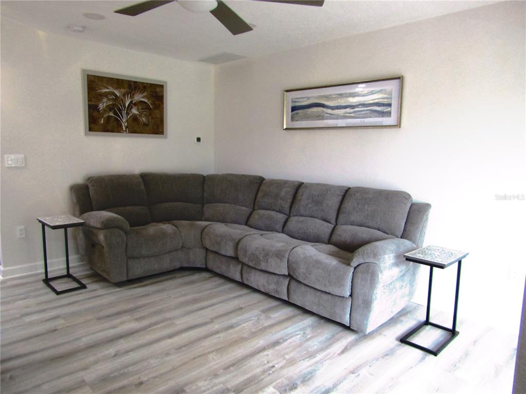 3531 Longmeadow, Unit 16 Sarasota, FL 34235 - Photo 7 of 29 a living room with furniture and a wooden floor