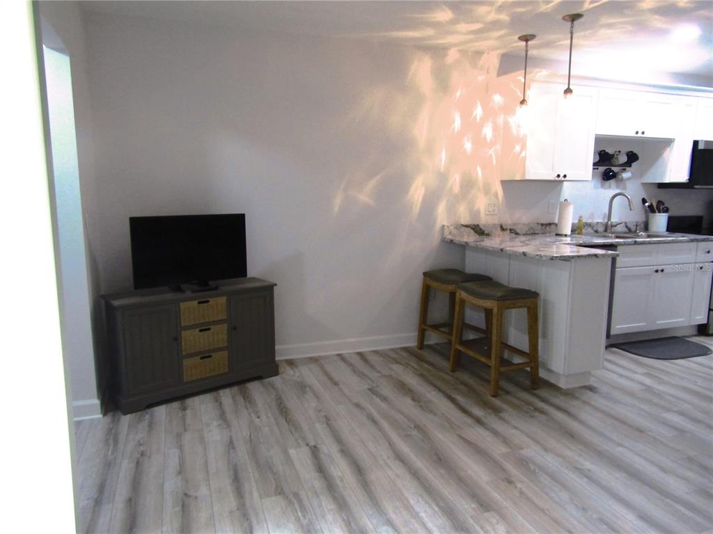 3531 Longmeadow, Unit 16 Sarasota, FL 34235 - Photo 8 of 29 a room with a chair and flat screen tv