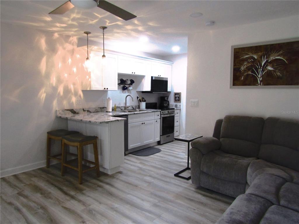 3531 Longmeadow, Unit 16 Sarasota, FL 34235 - Photo 9 of 29 a living room with furniture and a large window