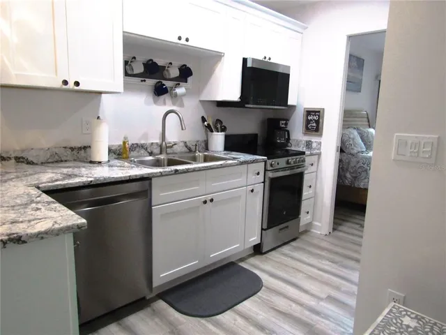 a kitchen with a sink stove and refrigerator