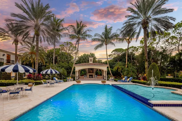 a front view of multi story residential apartment building with yard and green space