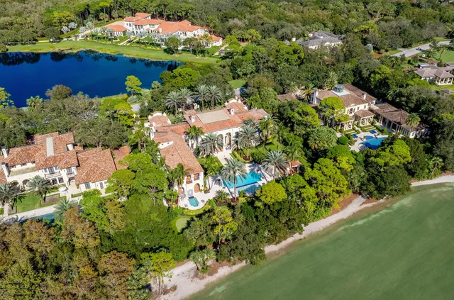a living room with furniture chandelier and a large window