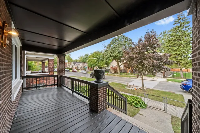 a view of a porch with wooden floor and iron stairs