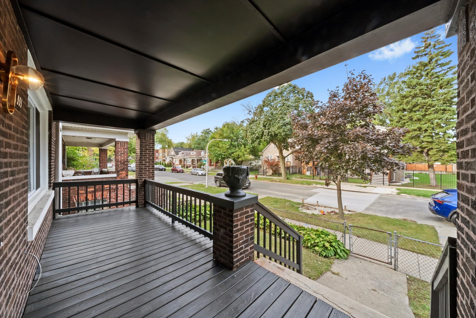 7955 South Colfax Avenue Chicago, IL 60617 - Photo 2 of 43 a view of a porch with wooden floor and iron stairs