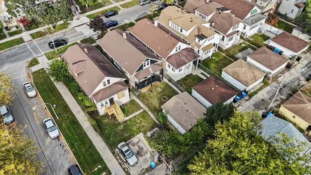 an aerial view of a house with a yard