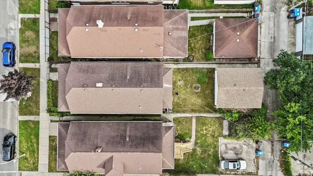 an aerial view of multiple houses with yard