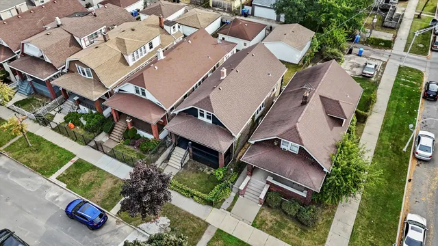 an aerial view of a house with a yard