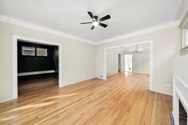 a view of empty room with wooden floor and fireplace