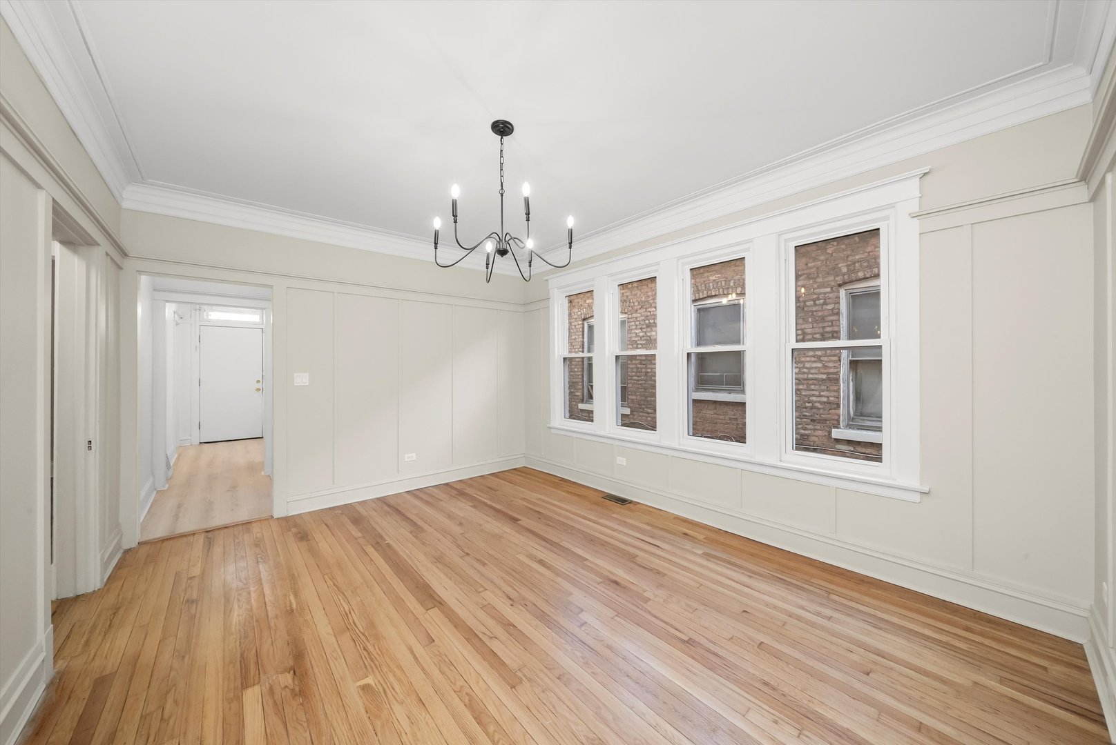 7955 South Colfax Avenue Chicago, IL 60617 - Photo 7 of 43 a view of empty room with wooden floor and fan