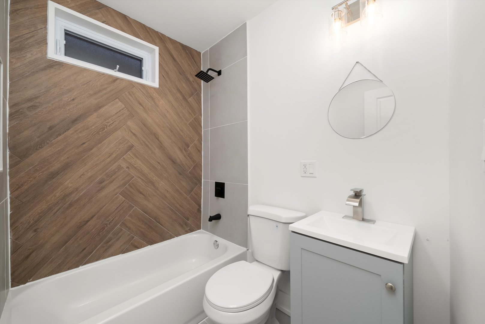 7955 South Colfax Avenue Chicago, IL 60617 - Photo 9 of 43 a bathroom with a toilet a sink and bathtub