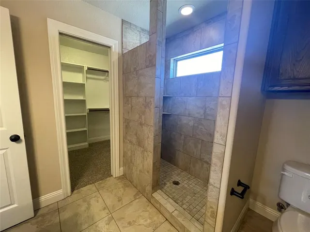 a bathroom with a shower and a sink