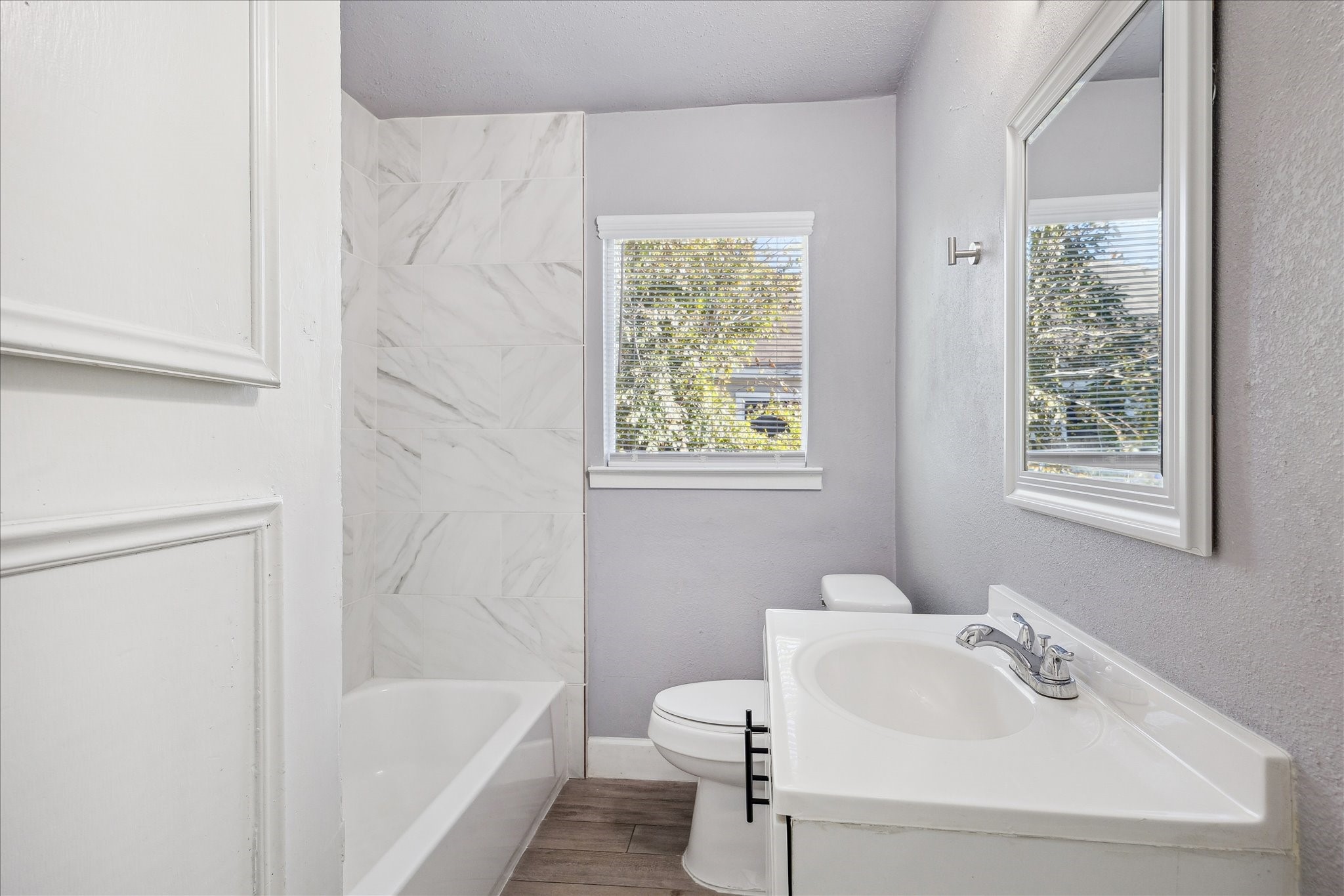 4523 Keystone Street Houston, TX 77021 - Photo 11 of 23 a white bath tub sitting next to a white sink and a toilet