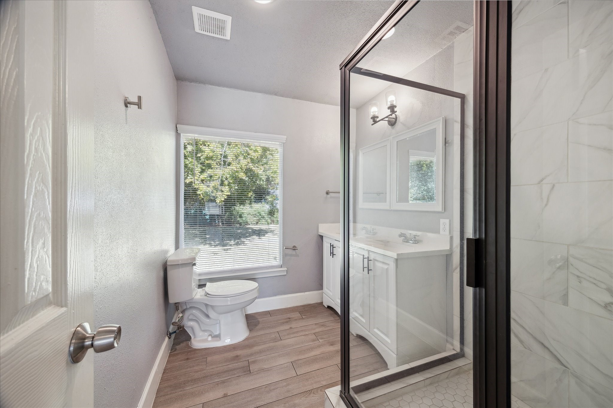 4523 Keystone Street Houston, TX 77021 - Photo 9 of 23 a bathroom with a granite countertop shower a toilet and a sink