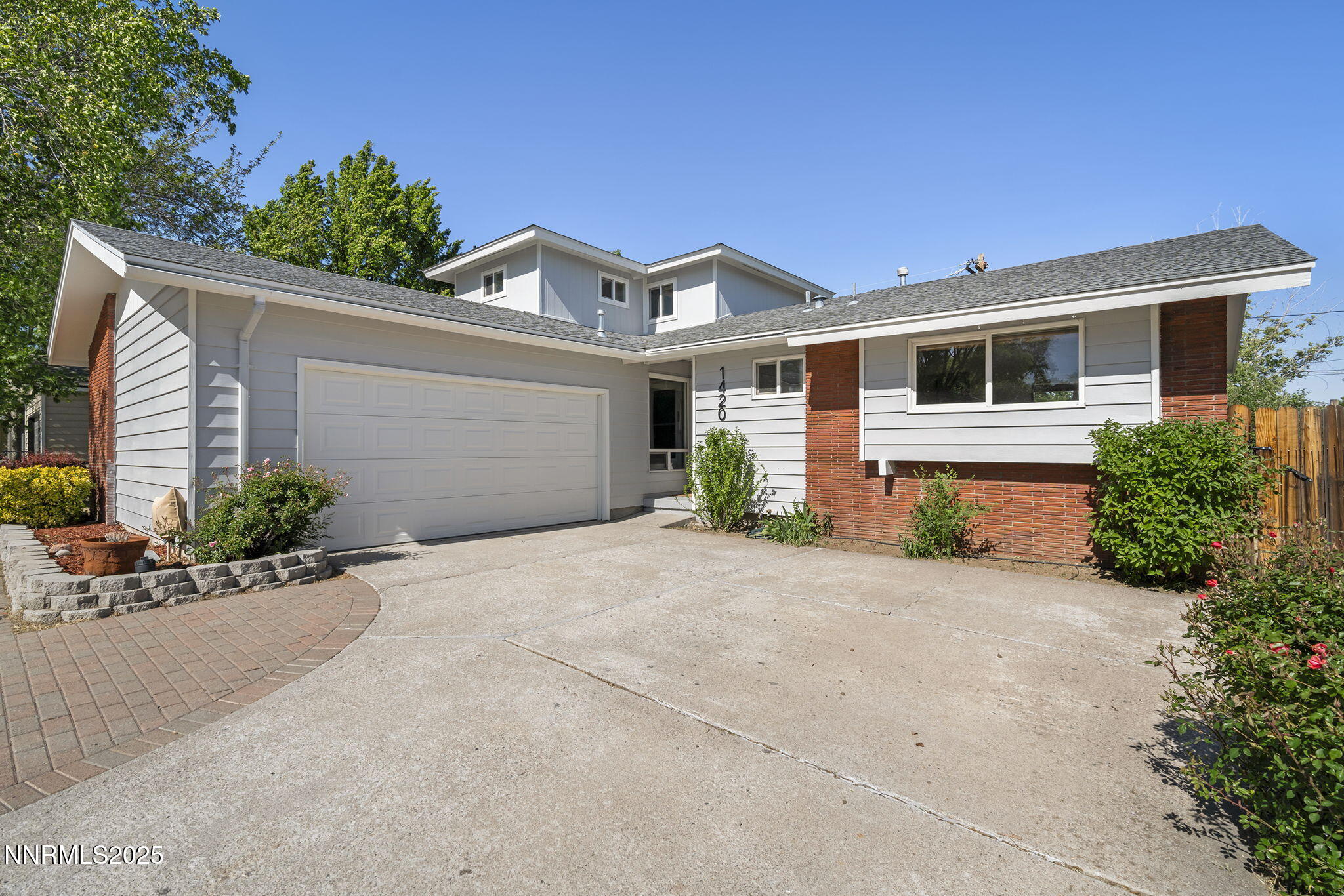 1420 Exeter Way Reno, NV 89503 - Photo 2 of 34 a front view of a house with a yard and garage