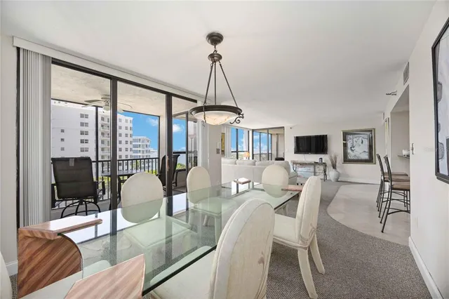 a living room with furniture large window and glass door