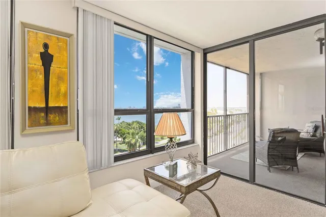 a living room with furniture and a floor to ceiling window