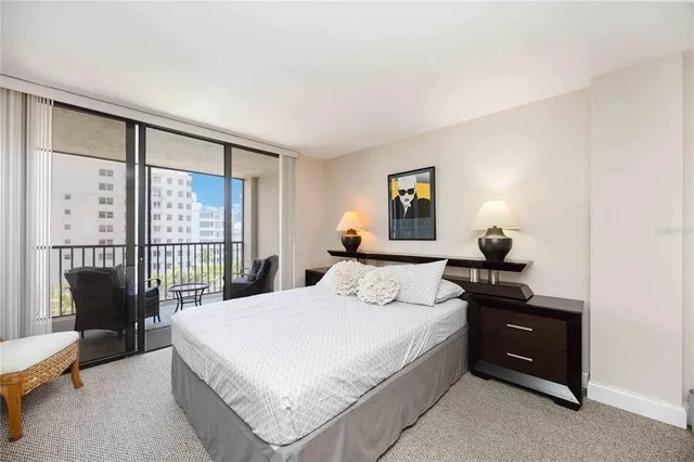 a bedroom with a bed lamp and a potted plant
