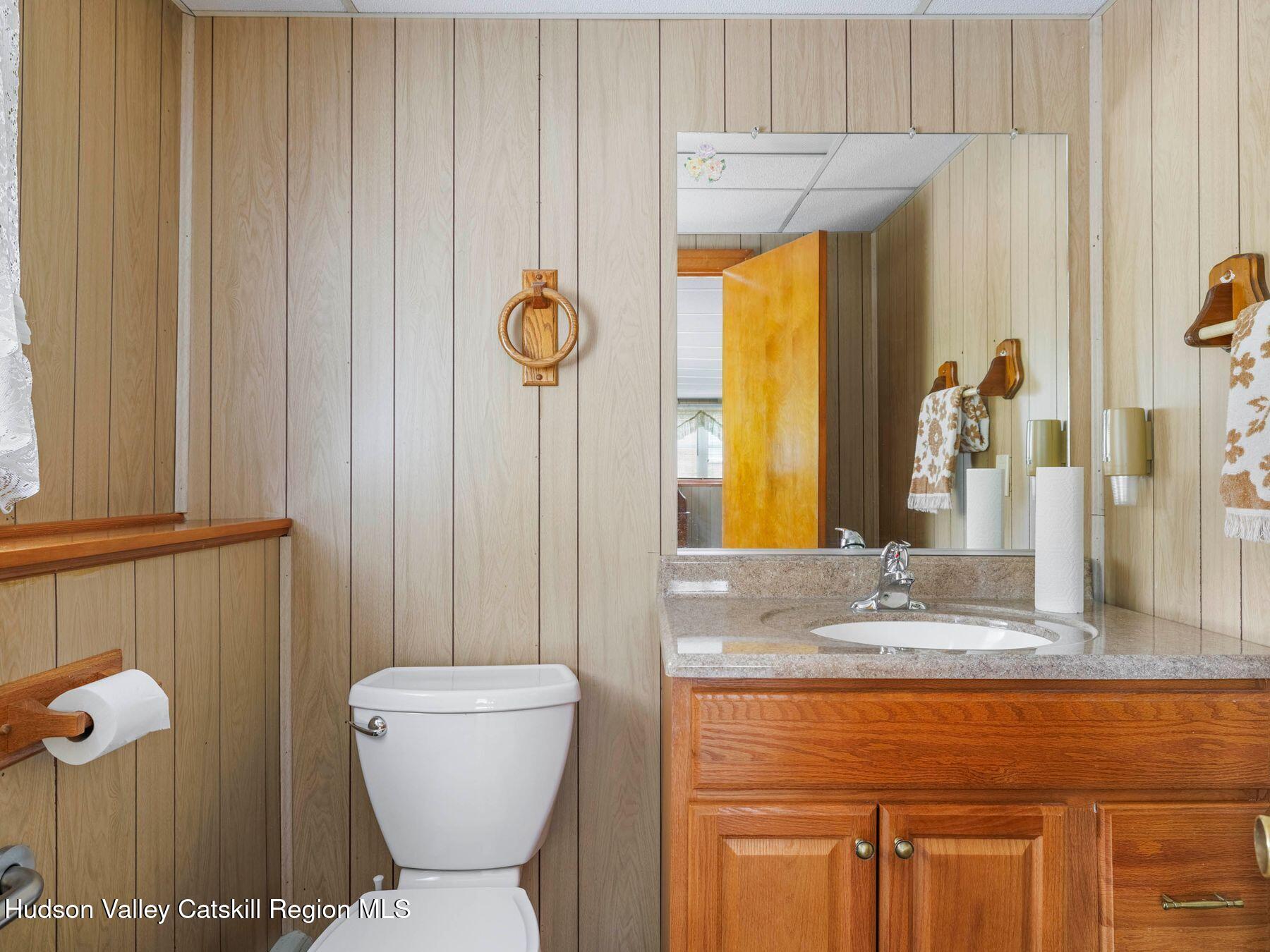 104 New Paltz Road Highland, NY 12528 - Photo 25 of 43 a bathroom with a sink a toilet and mirror
