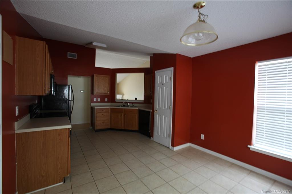 5004 Deerton Road Charlotte, NC 28269 - Photo 3 of 7 a kitchen with a refrigerator and a sink