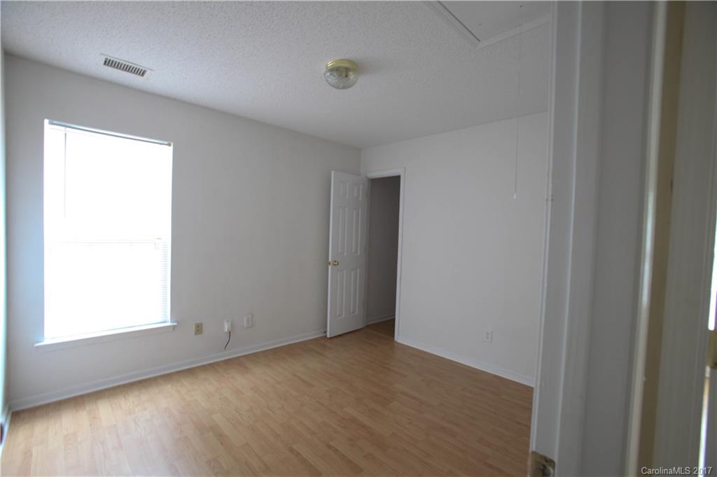 5004 Deerton Road Charlotte, NC 28269 - Photo 4 of 7 a view of an empty room with wooden floor and a window