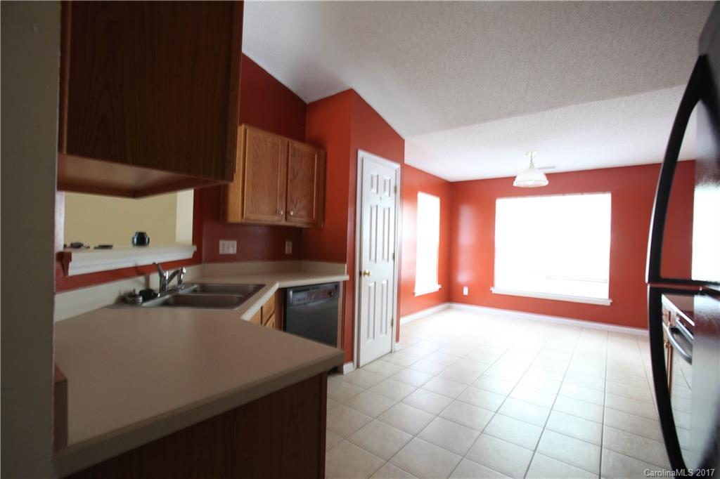 5004 Deerton Road Charlotte, NC 28269 - Photo 6 of 7 a kitchen with a sink a stove and a refrigerator