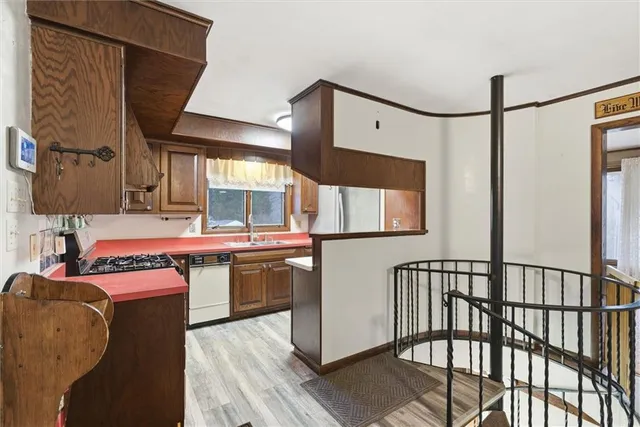 a kitchen with stainless steel appliances granite countertop a stove a sink and a refrigerator