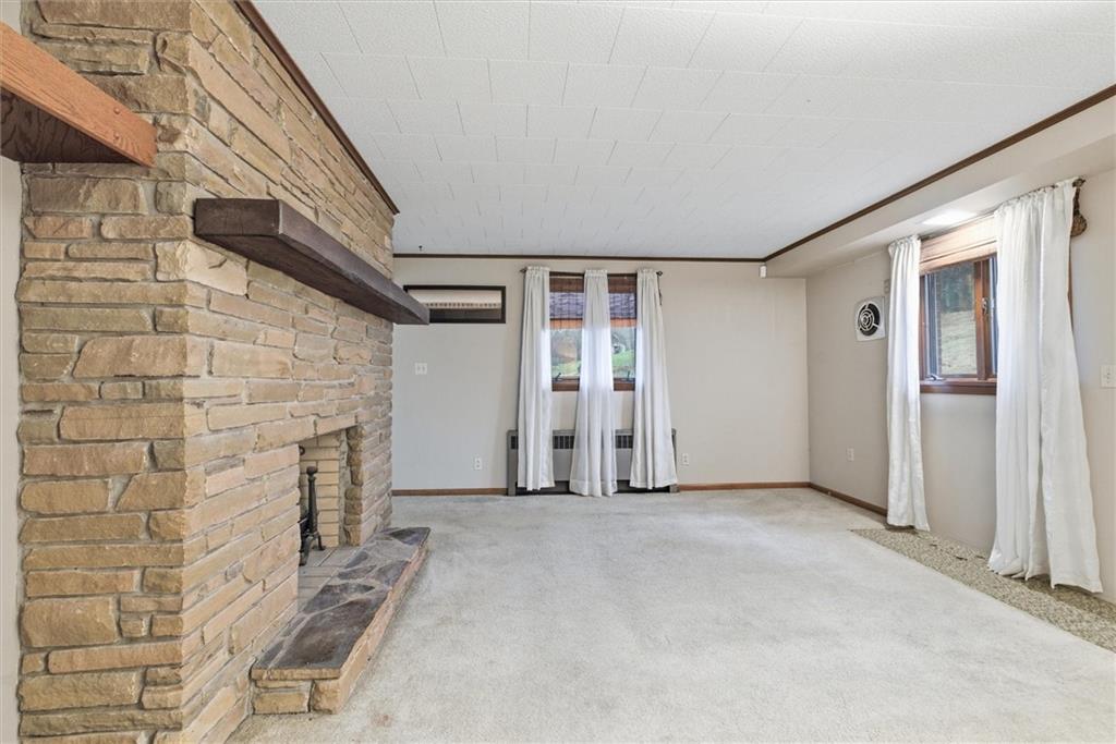 312 Flatwoods Road Vanderbilt, PA 15486 - Photo 25 of 50 a view of an empty room with wooden floor and a fireplace