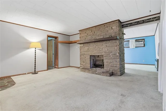 a view of an empty room with a fireplace