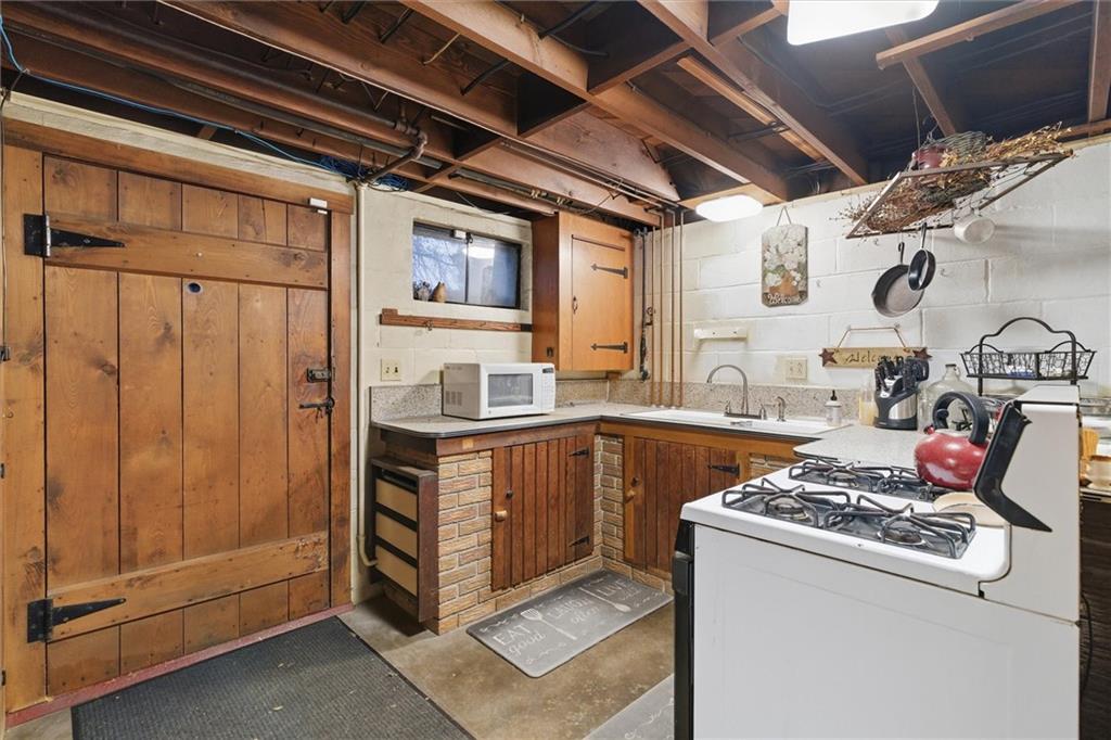 312 Flatwoods Road Vanderbilt, PA 15486 - Photo 34 of 50 a kitchen with stainless steel appliances granite countertop a stove and a refrigerator
