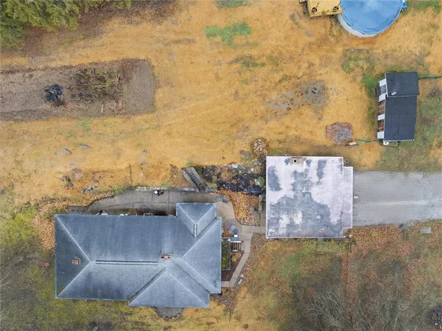 an aerial view of a house with a yard