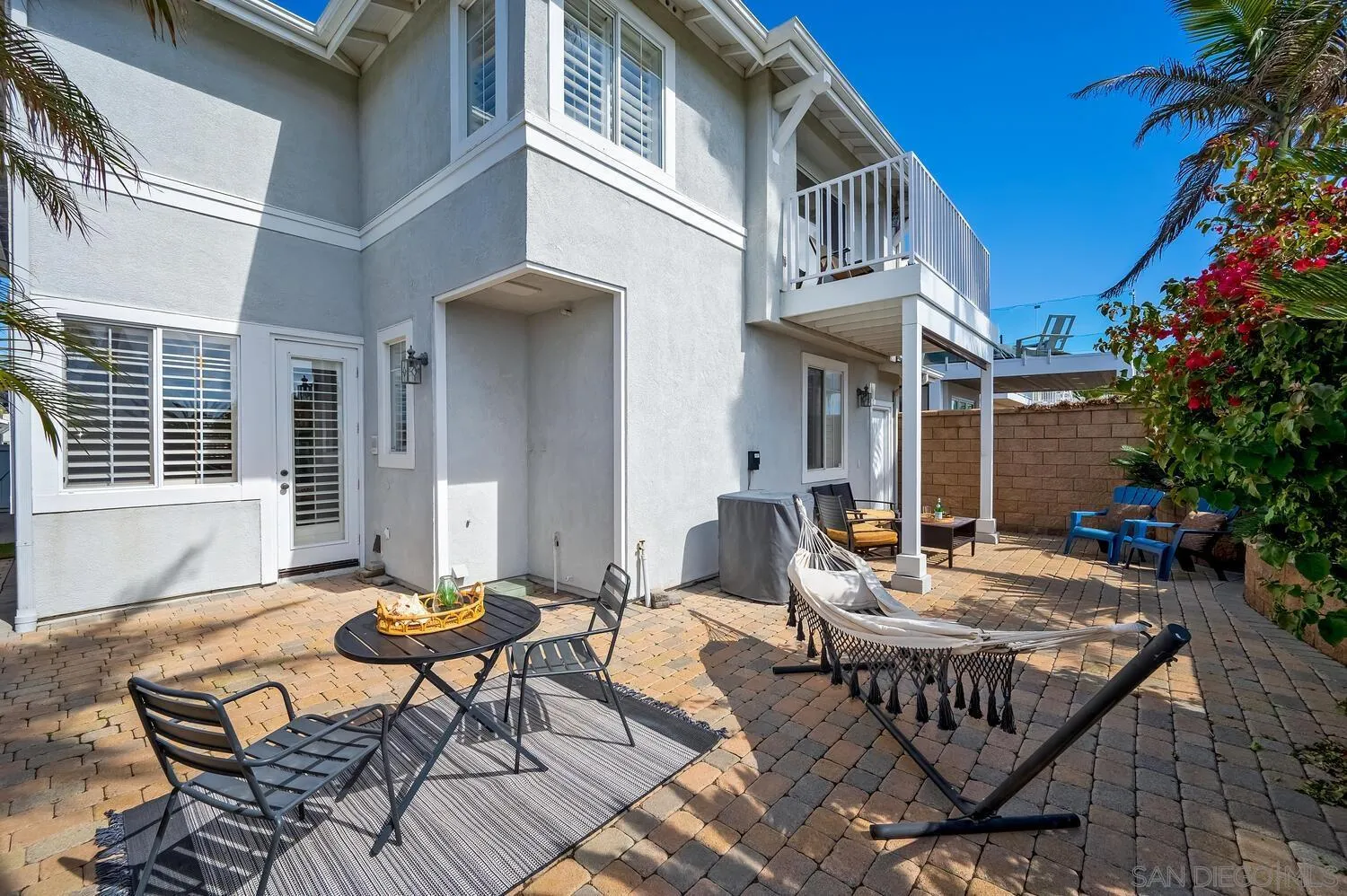 6891 Tradewinds Drive Carlsbad, CA 92011 - Photo 14 of 55 a backyard of a house with outdoor seating
