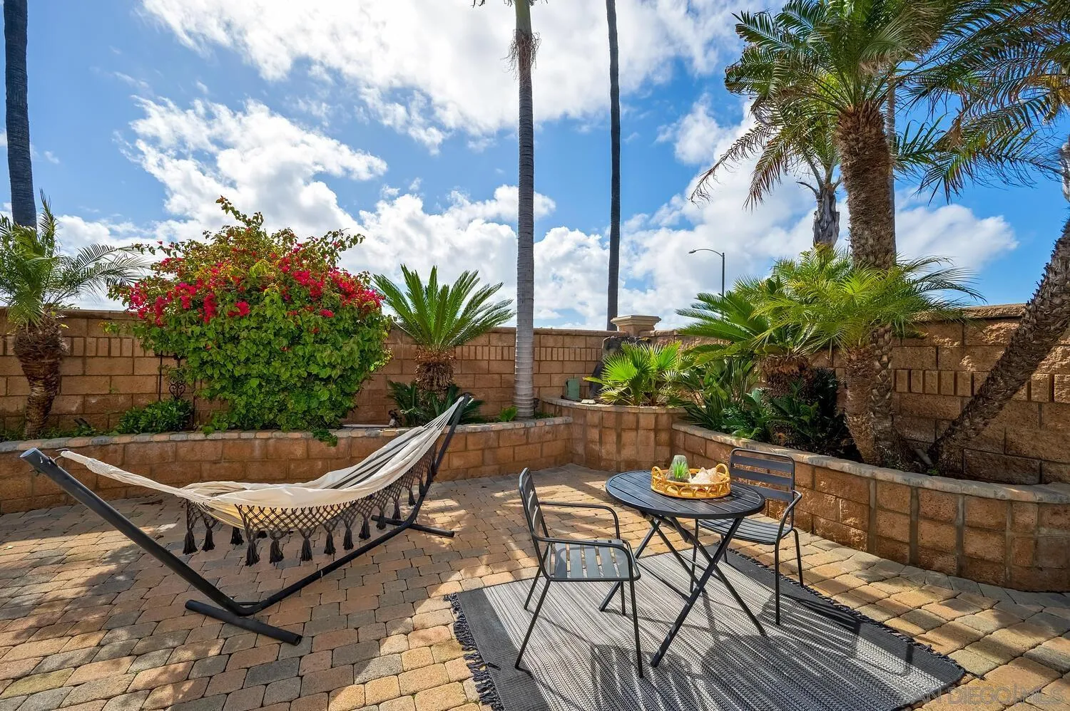 6891 Tradewinds Drive Carlsbad, CA 92011 - Photo 15 of 55 a backyard of a house with table and chairs