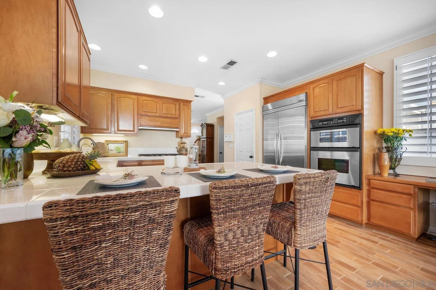 6891 Tradewinds Drive Carlsbad, CA 92011 - Photo 23 of 55 a kitchen with stainless steel appliances granite countertop a stove a sink and a refrigerator