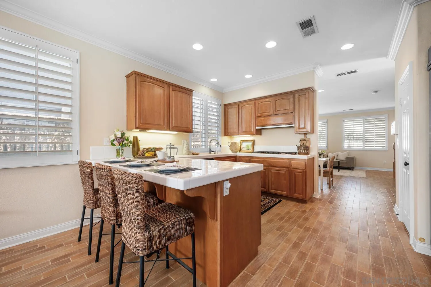 6891 Tradewinds Drive Carlsbad, CA 92011 - Photo 24 of 55 a kitchen with a table chairs sink and cabinets