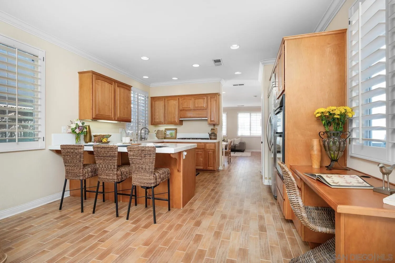 6891 Tradewinds Drive Carlsbad, CA 92011 - Photo 25 of 55 a living room with stainless steel appliances dining table wooden floor and a large window