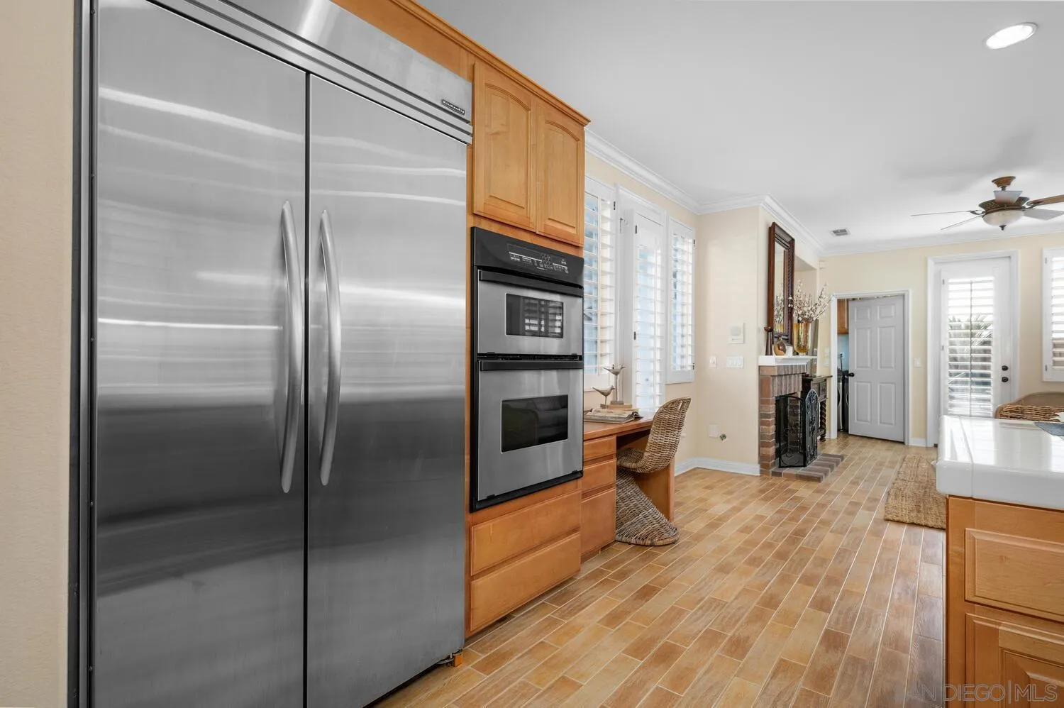 6891 Tradewinds Drive Carlsbad, CA 92011 - Photo 26 of 55 a kitchen with stainless steel appliances refrigerator and wooden floor