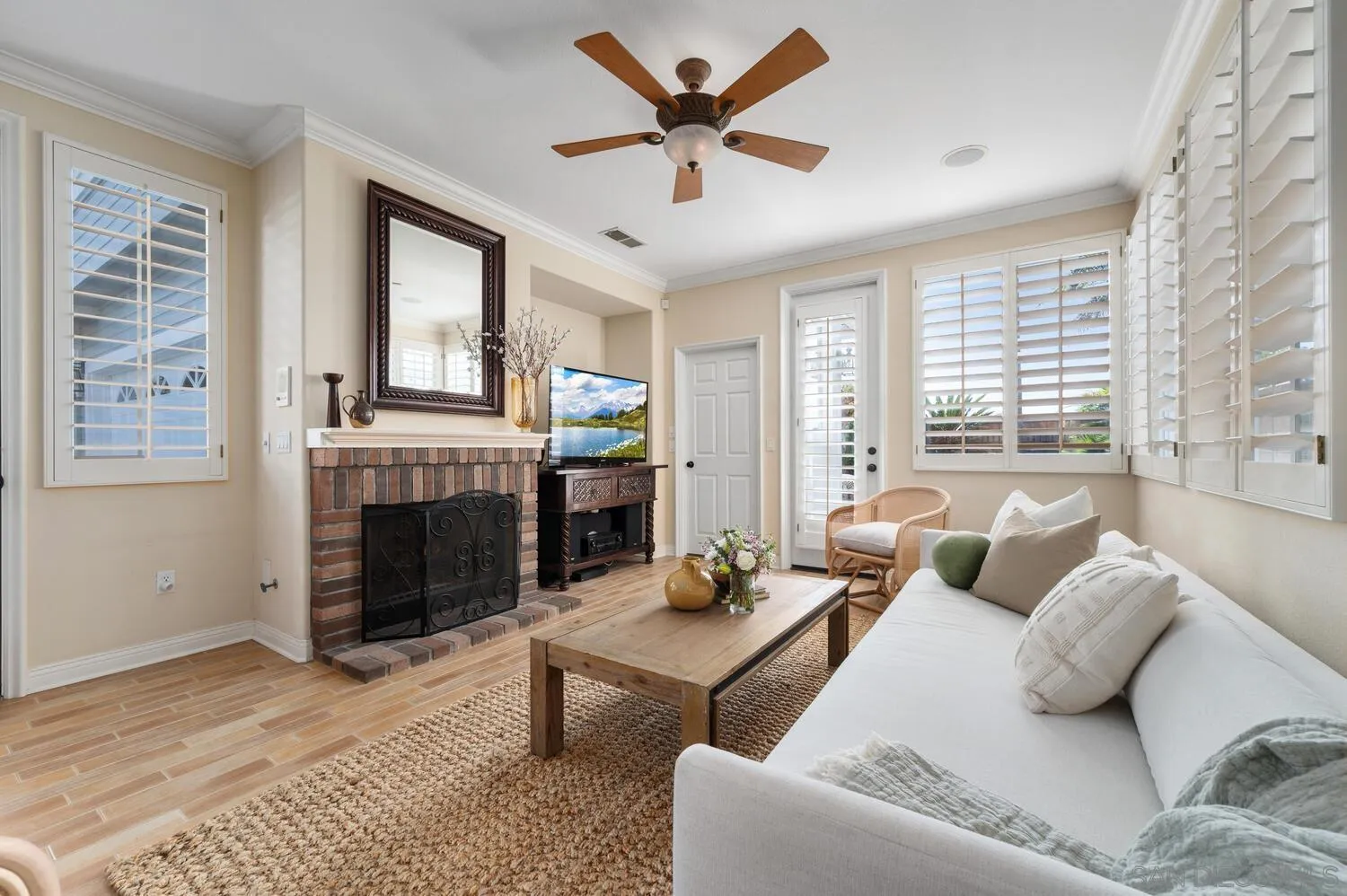 6891 Tradewinds Drive Carlsbad, CA 92011 - Photo 28 of 55 a living room with furniture a fireplace and a large window
