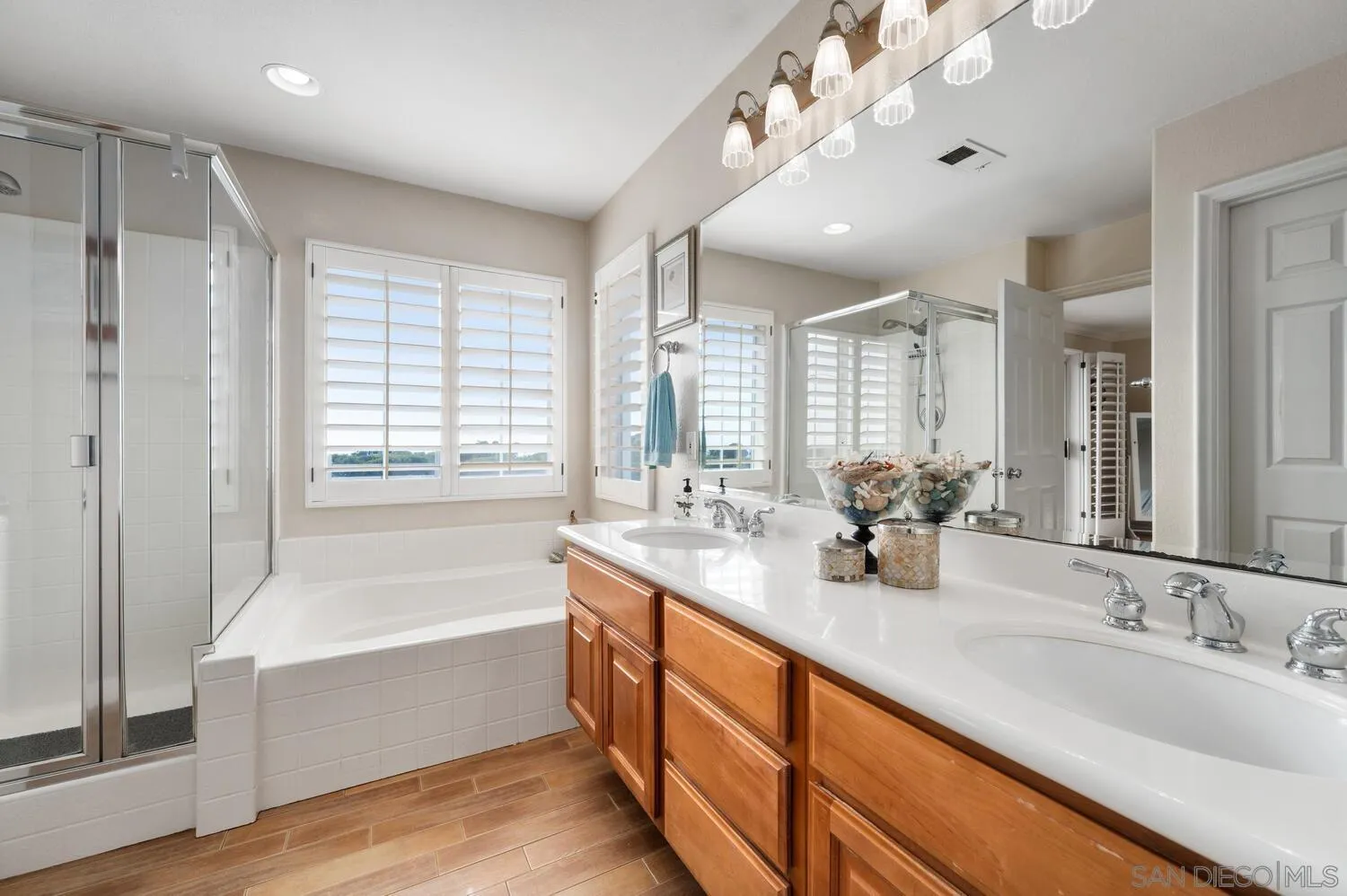 6891 Tradewinds Drive Carlsbad, CA 92011 - Photo 34 of 55 a bathroom with a tub sink and mirror