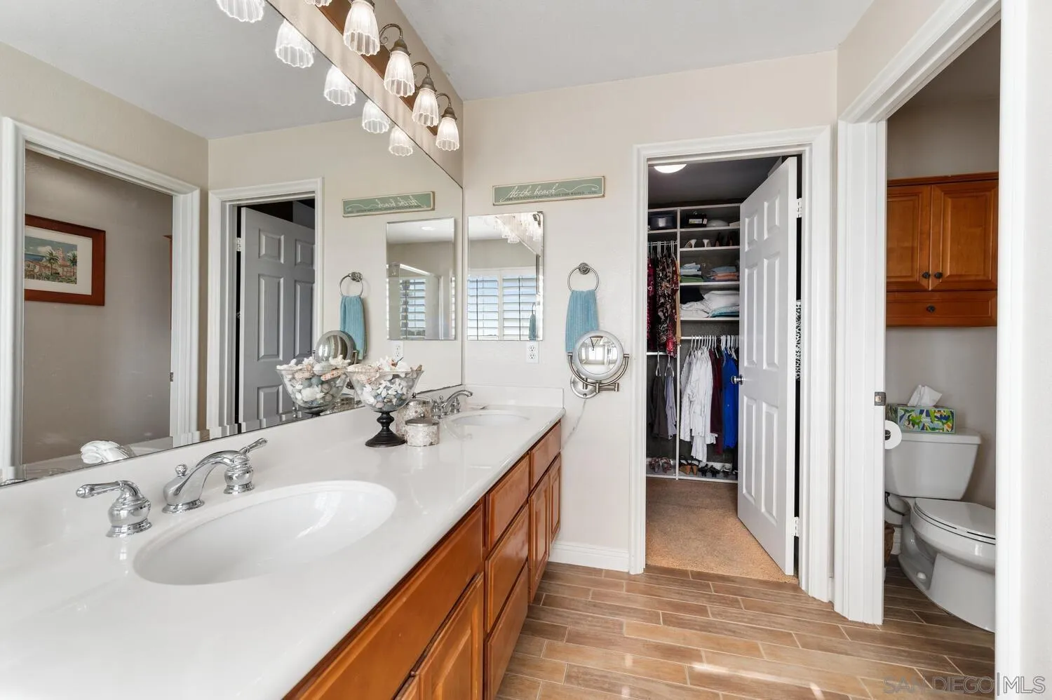 6891 Tradewinds Drive Carlsbad, CA 92011 - Photo 35 of 55 a en suite bathroom with a double vanity sink a large mirror and a shower