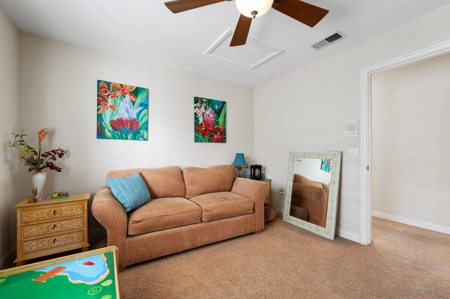 6891 Tradewinds Drive Carlsbad, CA 92011 - Photo 37 of 55 a living room with furniture and a baby crib