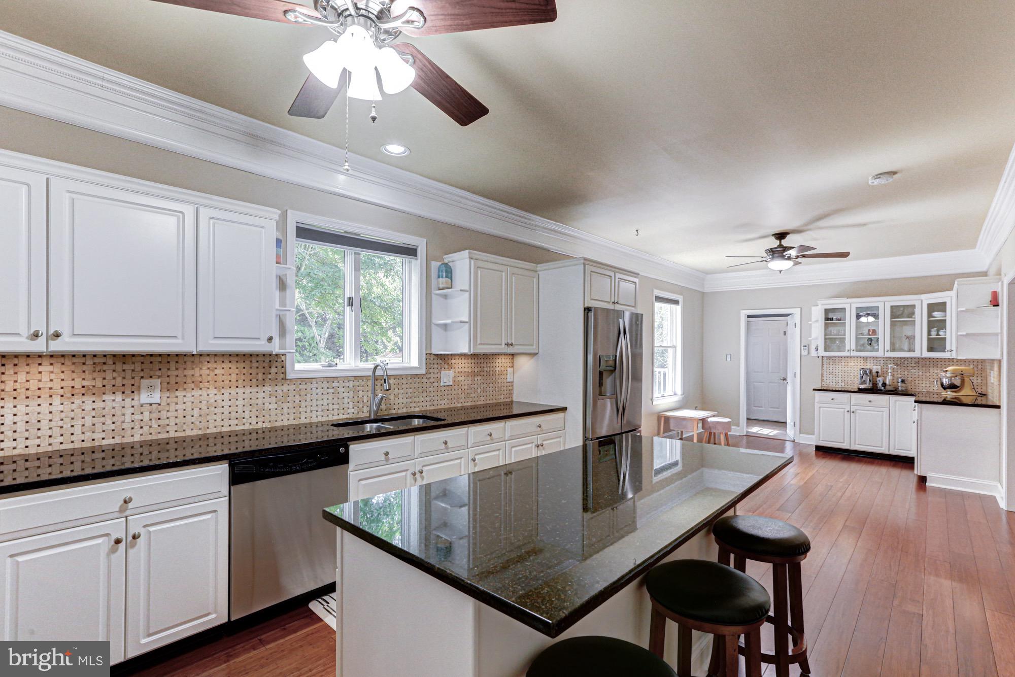 104 Dungarvan Drive Middletown, DE 19709 - Photo 16 of 45 a kitchen with stainless steel appliances granite countertop a kitchen island hardwood floor sink stove dining table and chairs