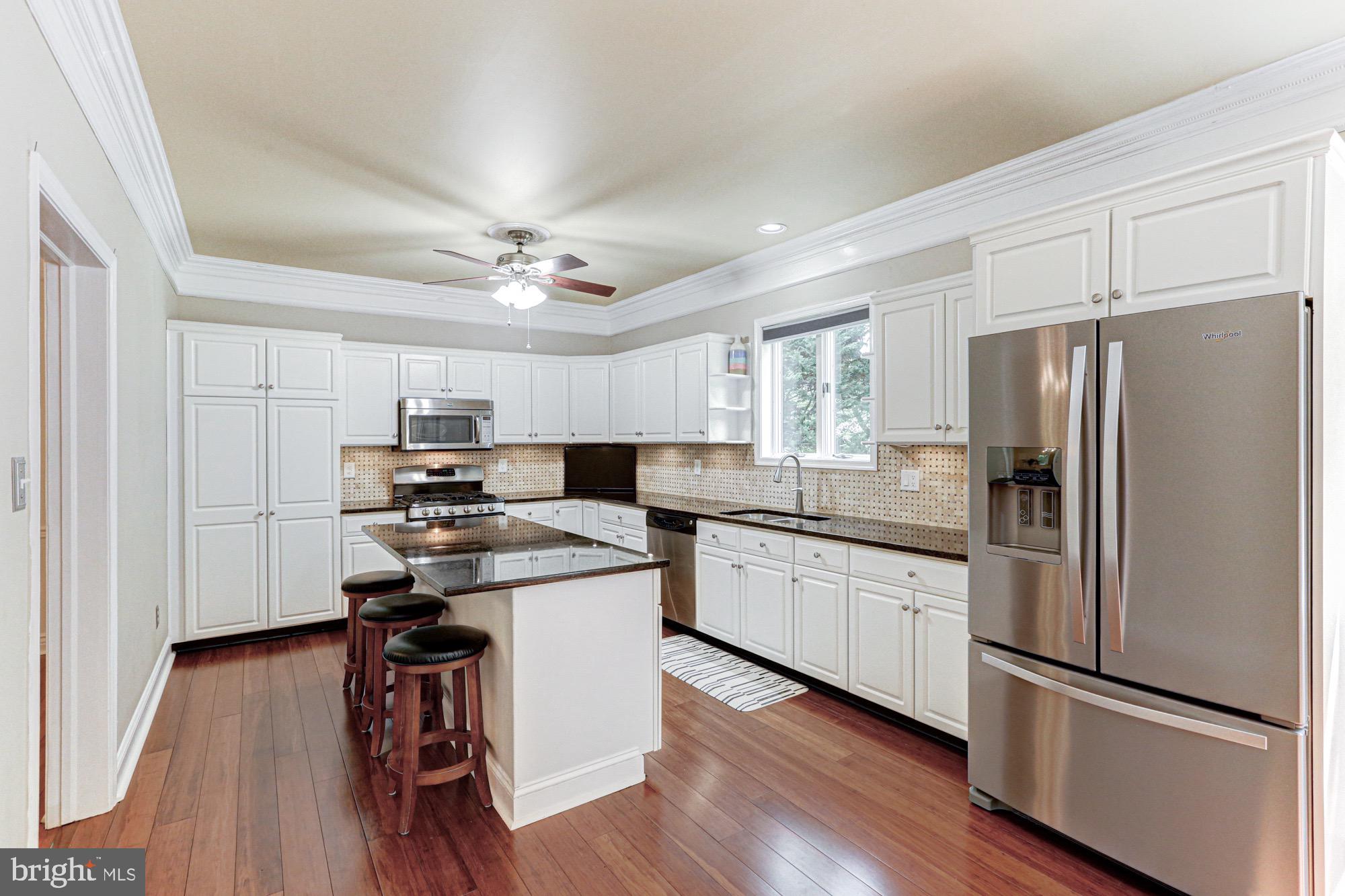 104 Dungarvan Drive Middletown, DE 19709 - Photo 17 of 45 a kitchen with stainless steel appliances a stove a sink dishwasher a refrigerator white cabinets and wooden floor