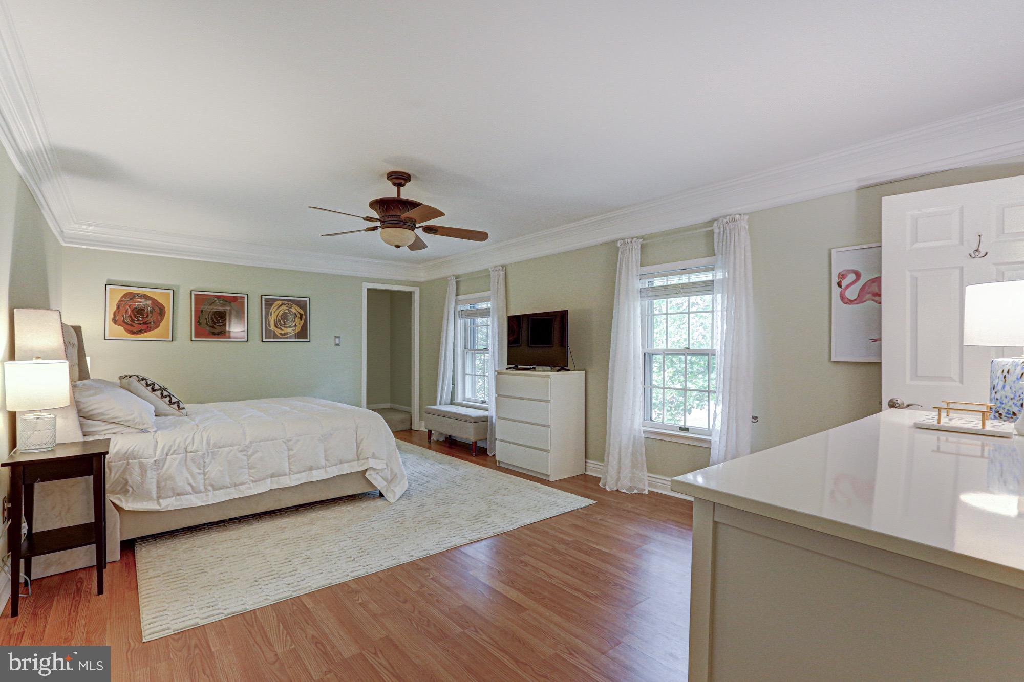 104 Dungarvan Drive Middletown, DE 19709 - Photo 28 of 45 a spacious bedroom with a large bed a chandelier and dresser