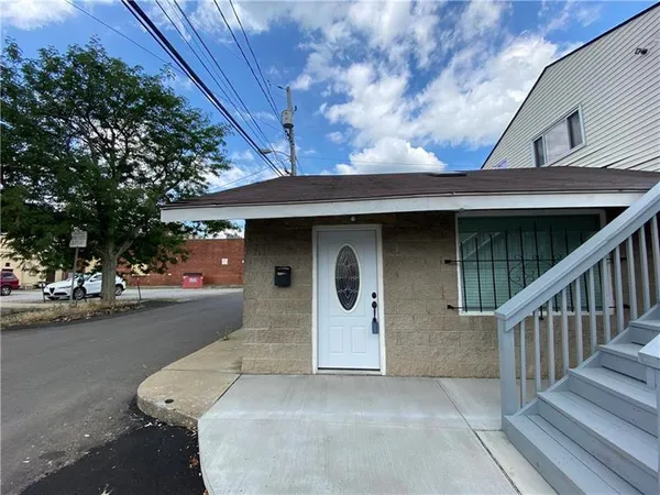 a front view of a house with stairs