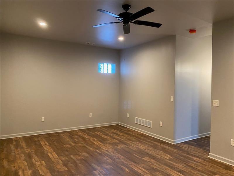 1108 4th Avenue Coraopolis, PA 15108 - Photo 14 of 15 an empty room with a ceiling fan and a window