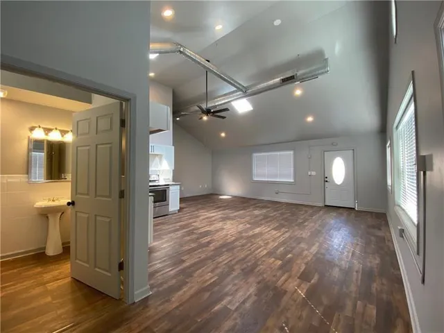 a view of a hallway with wooden floor