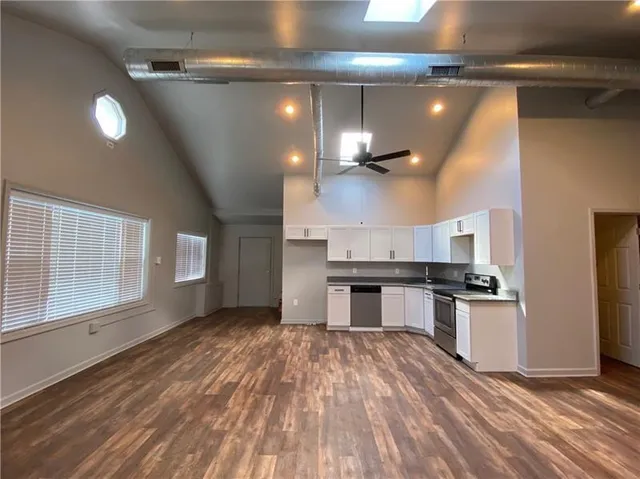 a kitchen with a stove and white cabinets