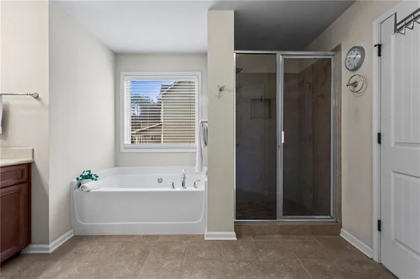 a bathroom with a bathtub and shower